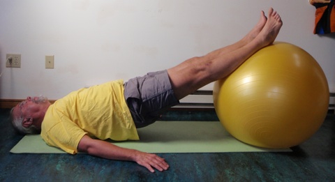 Coach John Hughes demonstrating bridging exercise for core strength training for cycling