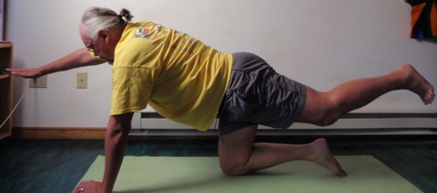 Coach John Hughes demonstrating kneeling back extension exercise for core training for cycling