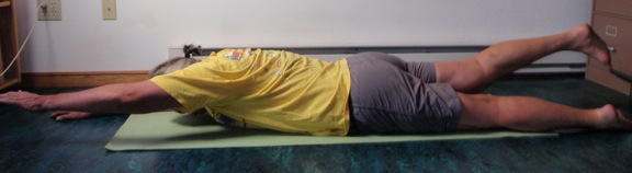 Coach John Hughes demonstrating lying back extension exercise for core training for cycling