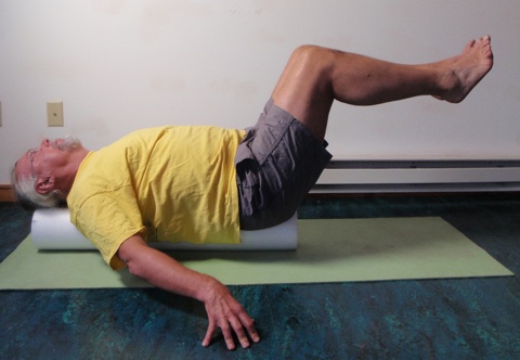 John Hughes demonstrating roller bent two leg raise exercise for core strength training for cyclists 