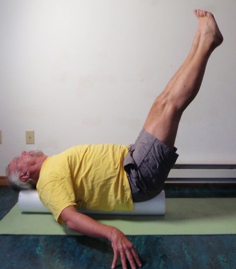 Coach John Hughes demonstrating Pilates circles exercise for core strength training for cyclists