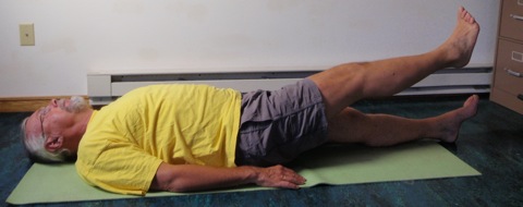 Coach John Hughes demonstrating straight leg raise exercise for core training for cycling